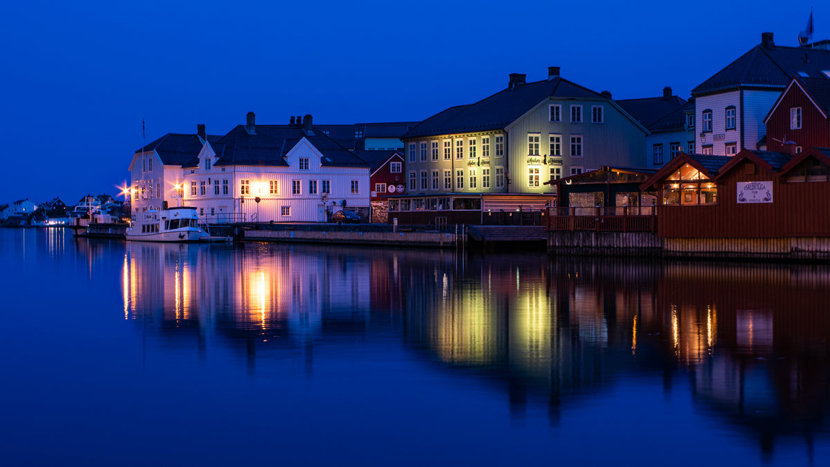 houses at night with lights reflecting on still water blue light reflection Traveling Burnside Project Birgit Fostervold Burnside